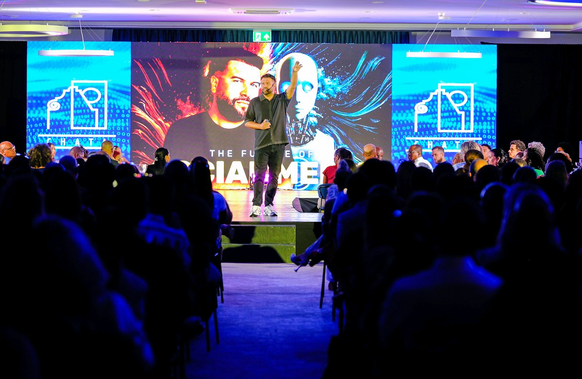 Speaker presenting on stage to a corporate summit audience Speaker presenting on stage to a corporate summit audience