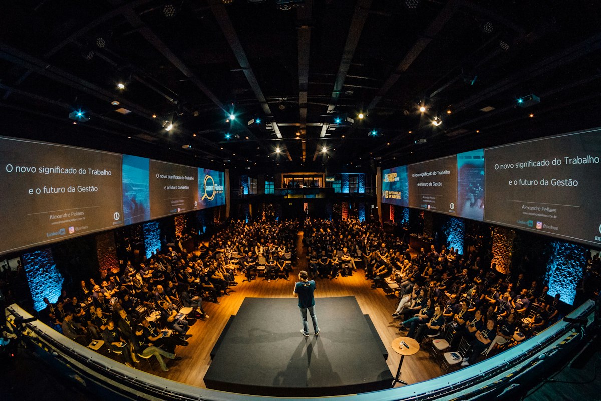 Speaker engaging a large summit audience Speaker engaging a large summit audience