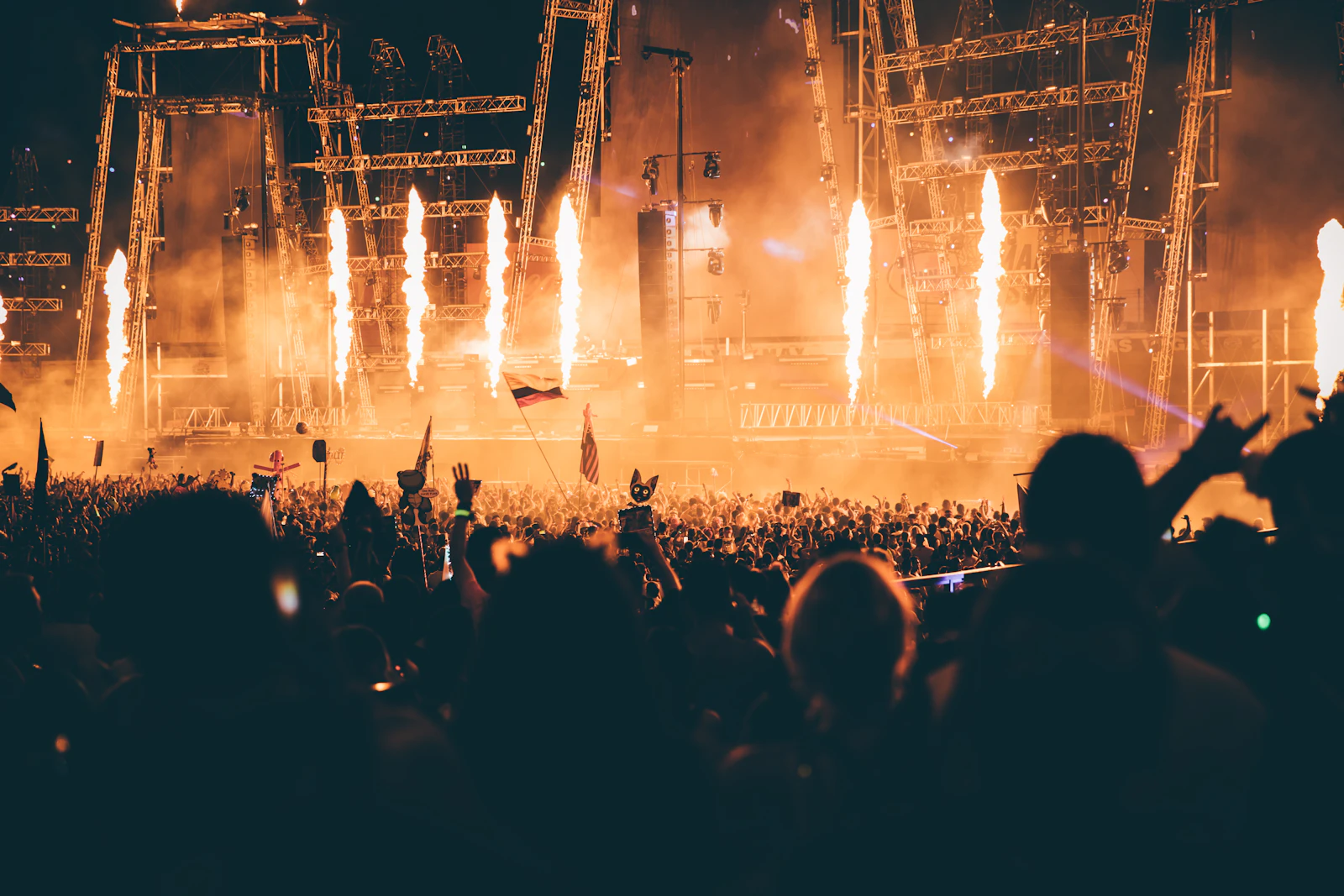 Concert lighting design with bright stage lights and effects above a crowd