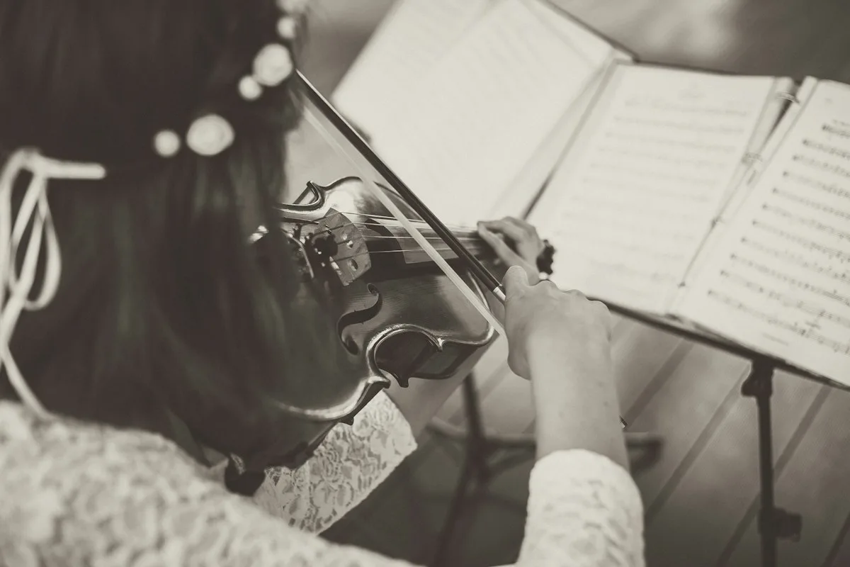 Wedding violinist playing acoustic violin music for a ceremony