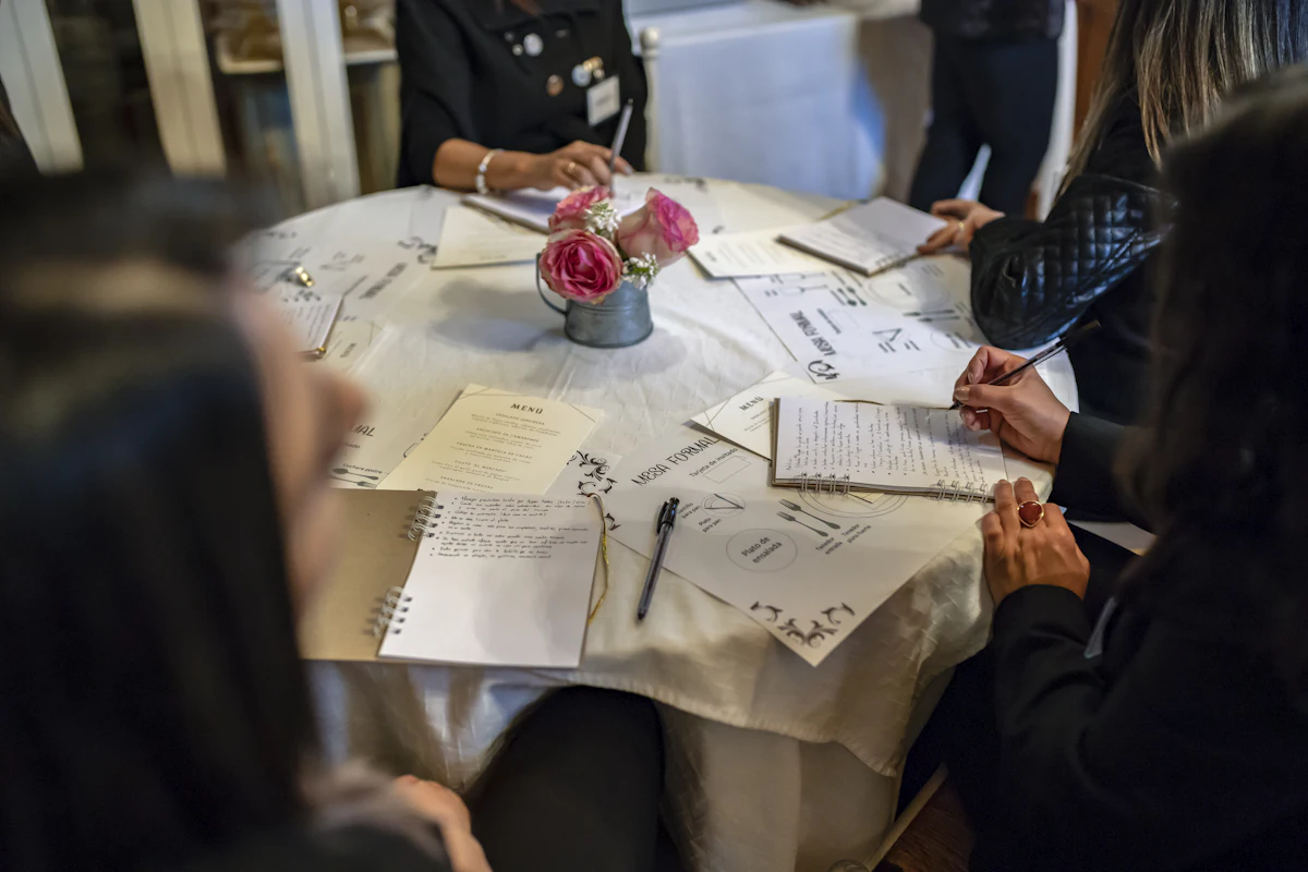 Event planner reviewing a vendor quotation with a client Event planner reviewing a vendor quotation with a client