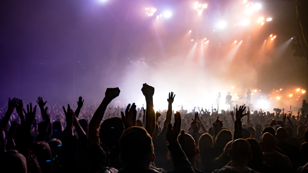 Concert audience facing a lighted stage at a live music event