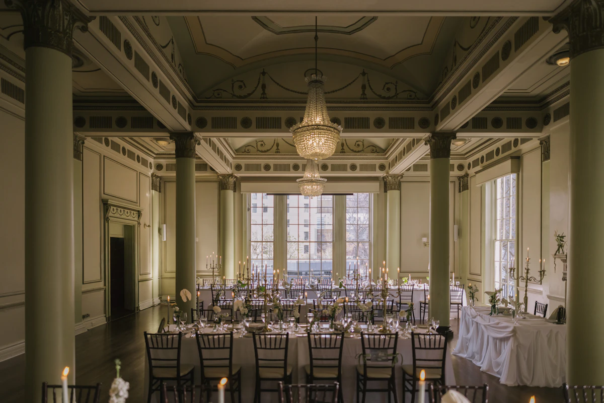 Elegant ballroom venue with long dinner tables and chandeliers set for a corporate gala in Dubai