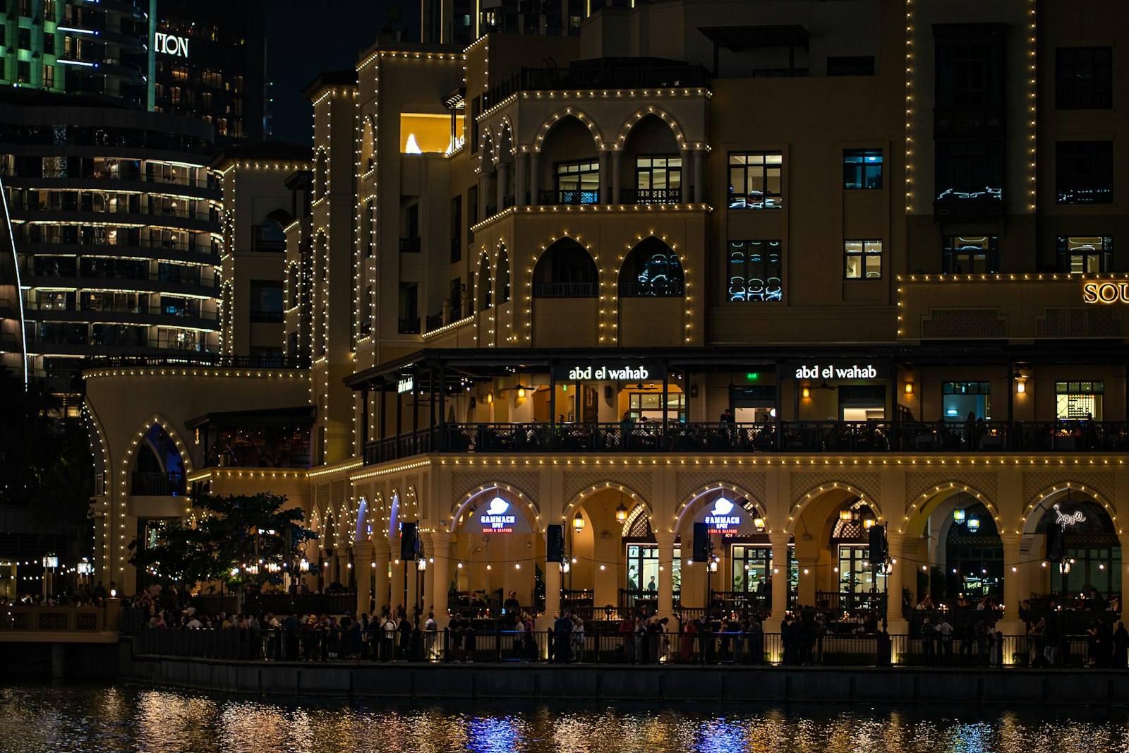 Waterfront restaurants lit up at night in Downtown Dubai