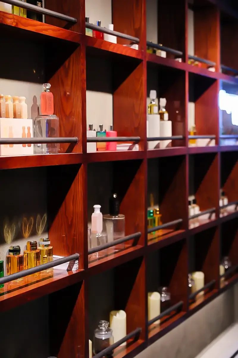 Perfume bottles displayed on shelves in the Fragrance Room at Someone’s House