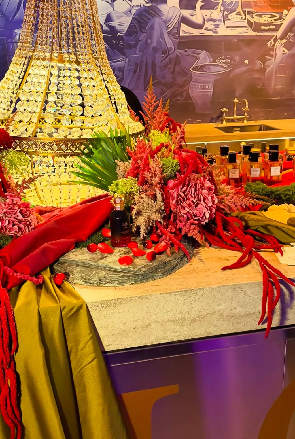 Lootah fragrance display with florals and chandelier at Someone’s House