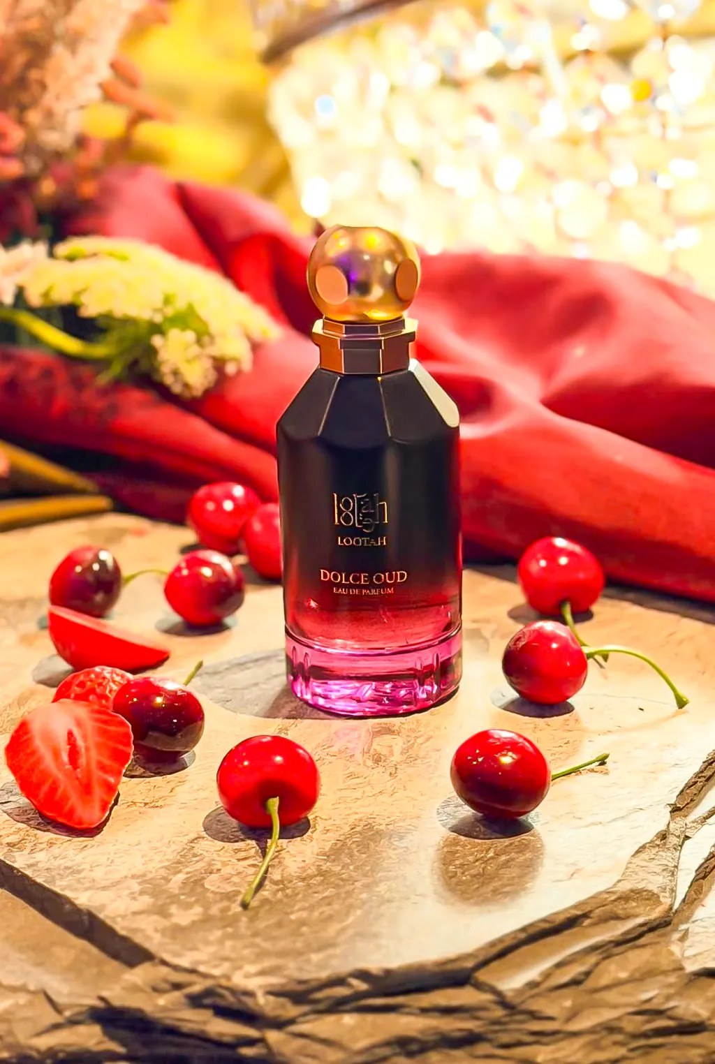 Lootah Dolce Oud bottle styled with cherries and strawberries