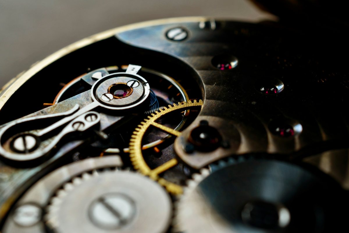 Close-up of an open mechanical watch movement showing gears and jewels