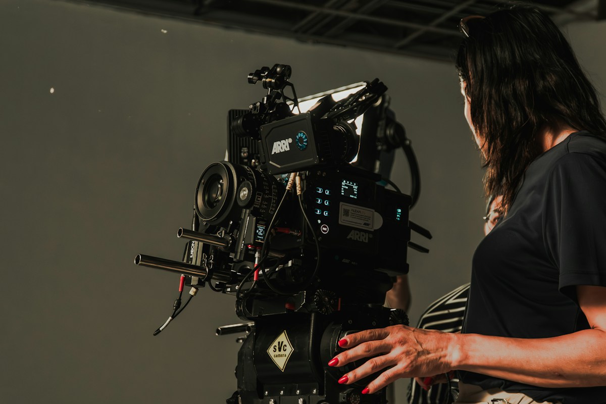 Camera operator filming a luxury brand campaign on a studio set