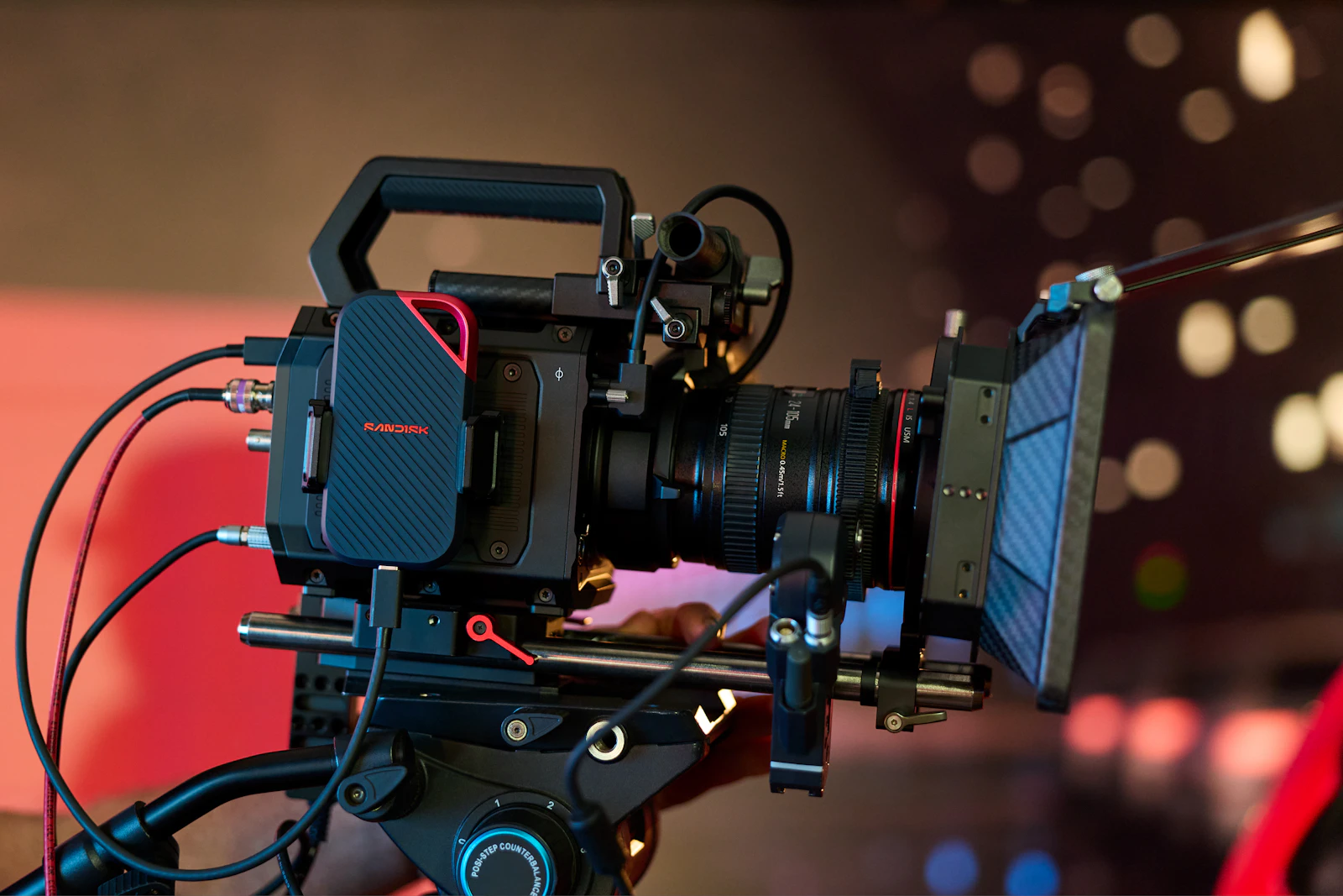 Professional cinema camera set up on a tripod for a commercial shoot Professional cinema camera set up on a tripod for a commercial shoot