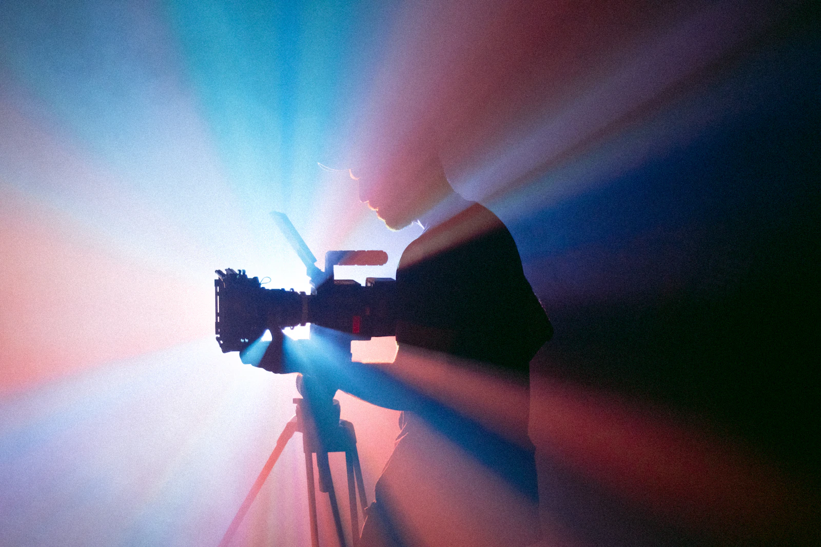 Camera operator filming a commercial shoot with studio lighting