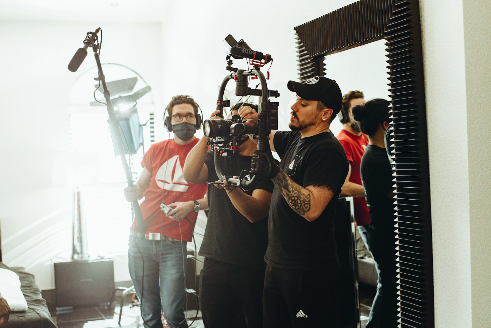 Film crew with boom microphone and camera on a commercial video shoot Film crew with boom microphone and camera on a commercial video shoot