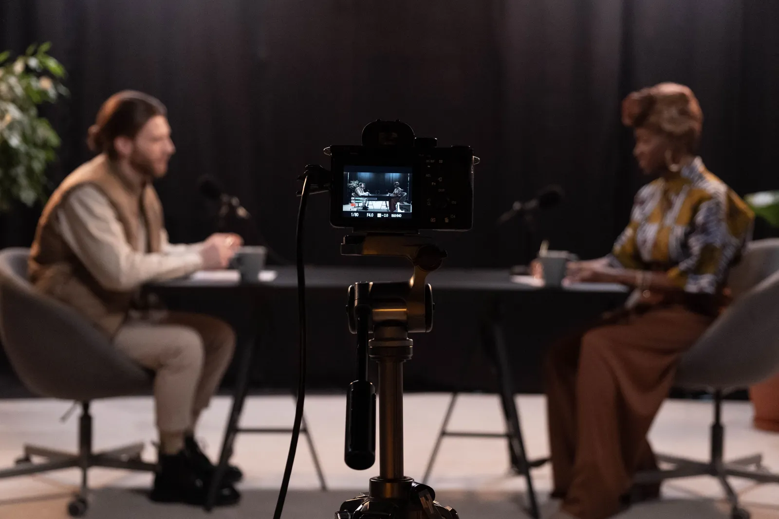 Seated interview set with camera framing the conversation