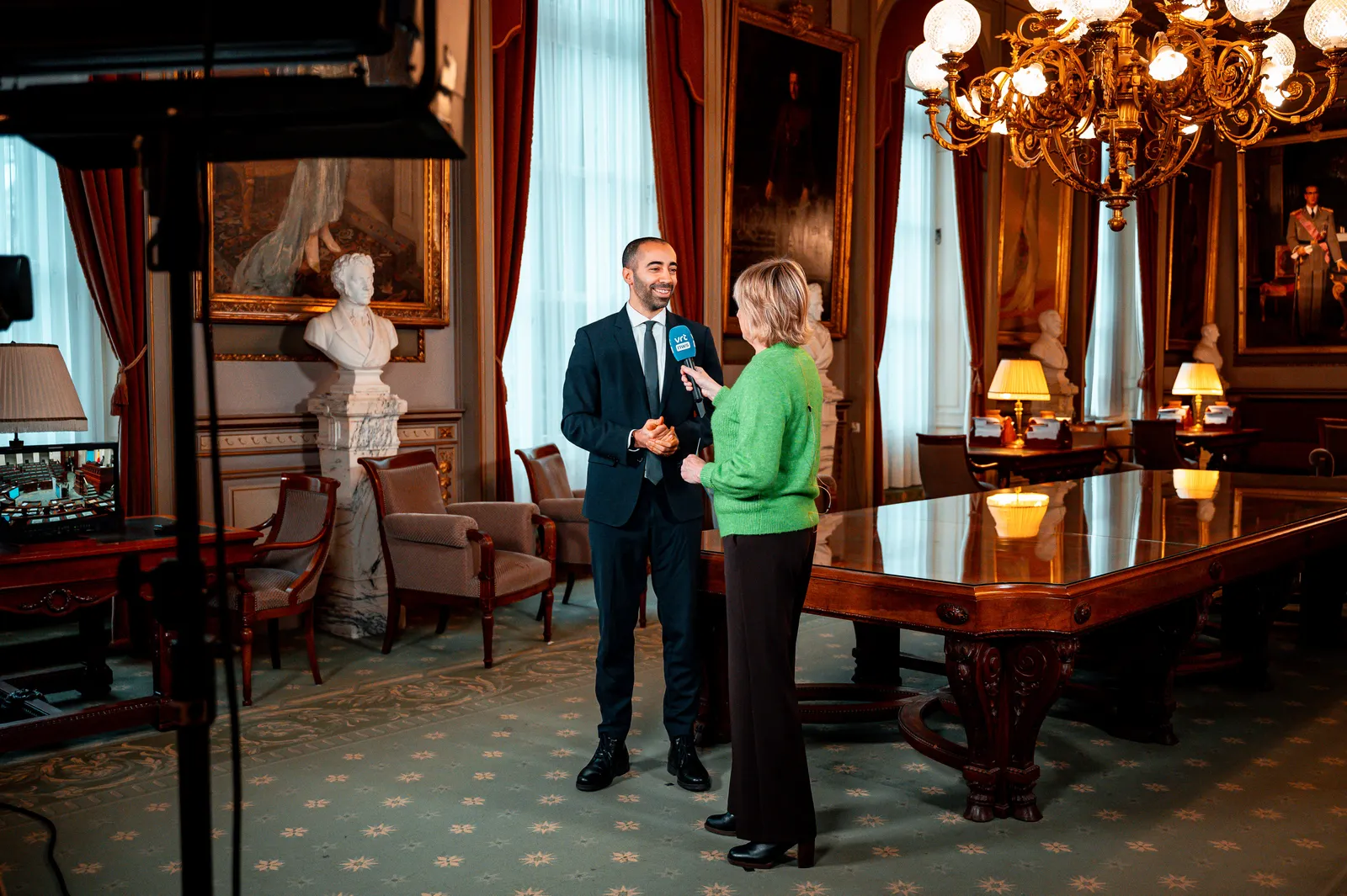 Executive giving a filmed interview in a boardroom