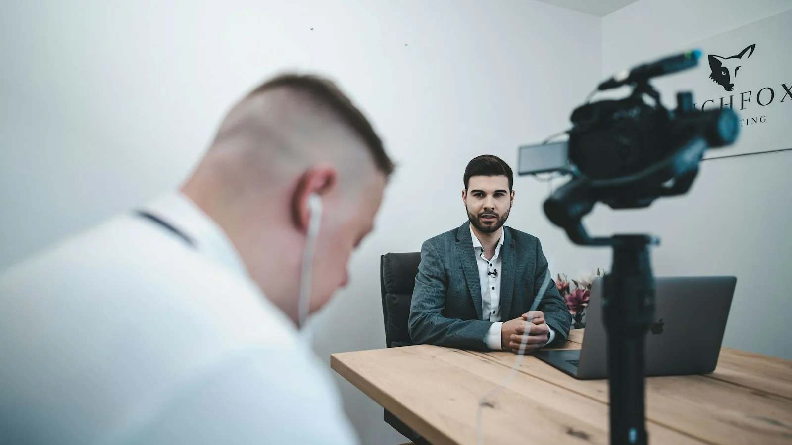 Business customer in a suit being filmed for a corporate testimonial interview